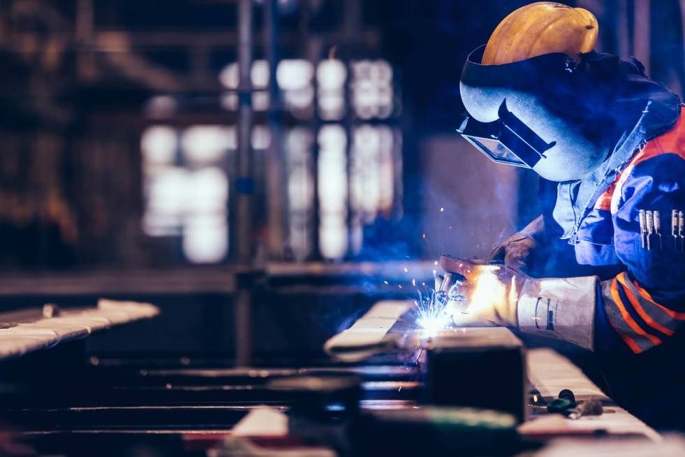 a welding professional is welding the iron items