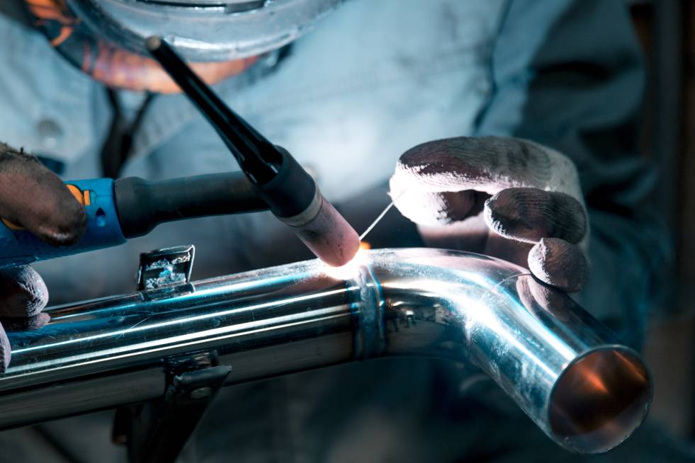 a welder is welding the pipe